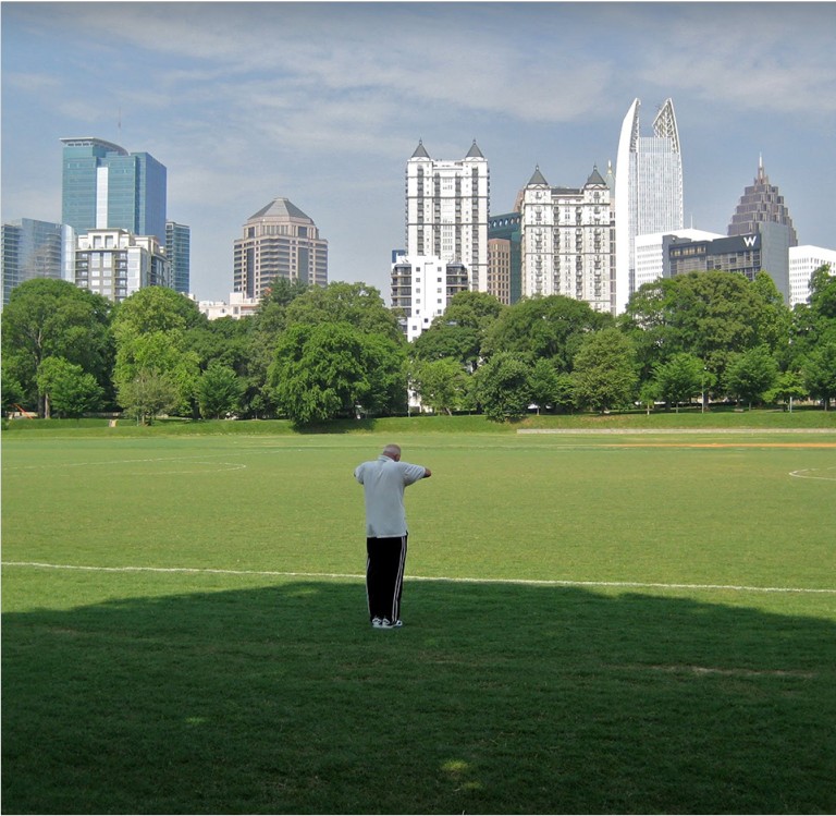 A man standing in green field